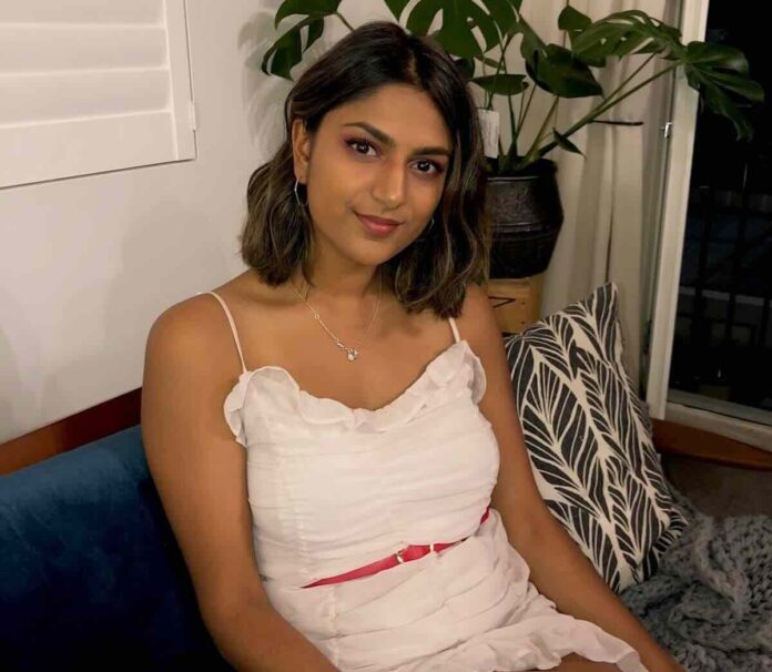 Picture of Premila Morar posing before the camera while sitting on a sofa